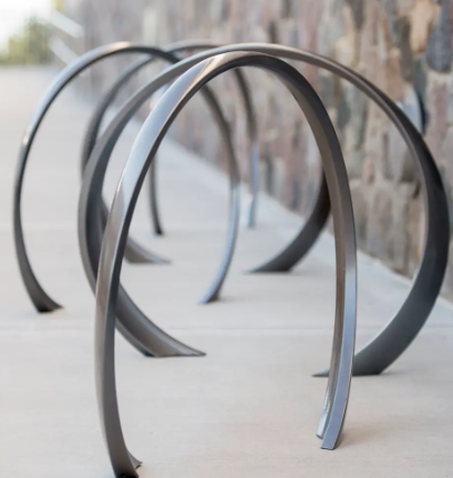 Bike Racks — sculptural loop racks along a walkway