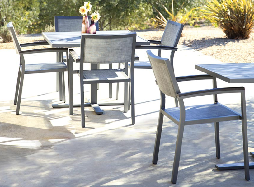 Pool Furniture — matching mesh chairs with arms in a commercial outdoor deck setting